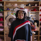 One of the subjects of Worn Stories in front of a wall of hats
